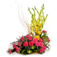 Deliver Christmas Flowers to Mumbai including 18 Pink Carnation 6 Yellow Glad Flower Basket to Mumbai