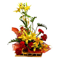 Christmas Flowers in Mumbai consist of 6 Yellow Lily 6 Red Carnation Arrangement of Flowers to Nashik