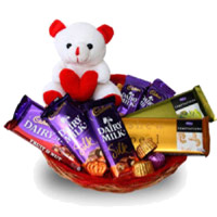 Place Order for New Year Gifts in Mumbai having 6 Inch Teddy Basket and Dairy Milk, Silk, Temptation Chocolates to Mumbai