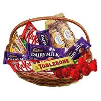 Diwali Gifts in Mumbai that include Basket of Assorted Chocolates in Panval with 10 Red Roses to Thane