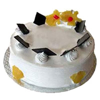 New Year Gifts in Mumbai Online. 1 Kg Eggless Pineapple Cake to Mumbai From 5 Star Bakery