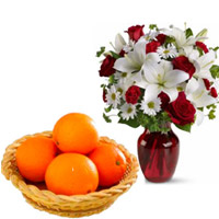 Same Day Christmas Gifts Delivery in Mumbai incorporate with 2 White Lily 6 White Gerbera 6 Red Roses Vase with 12 pcs Fresh Orange Basket in Amravati